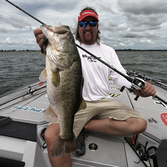 a person holding a fish on a boat